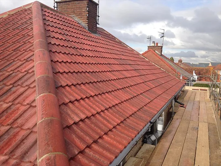 A Newline re-roof in progress with fresh clay pantiles and scaffolding
