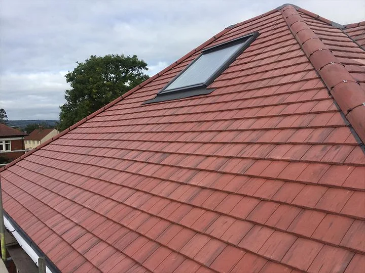 A Newline new plain-tile pitched roof with a roof window