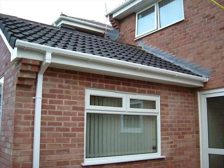 Newline new white fascias, soffits and guttering on a brick house